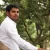 handsome-indian-man-meditating-under-tree-27166536